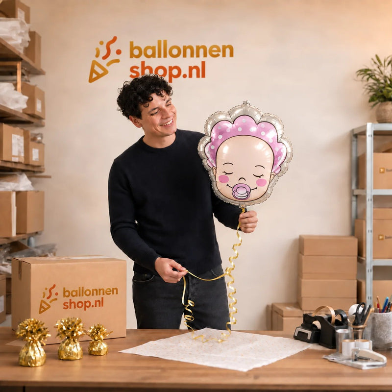 Jesse houdt de Baby Helium Ballon Meisje vast in de warme werkplaats van Ballonnenshop.nl.