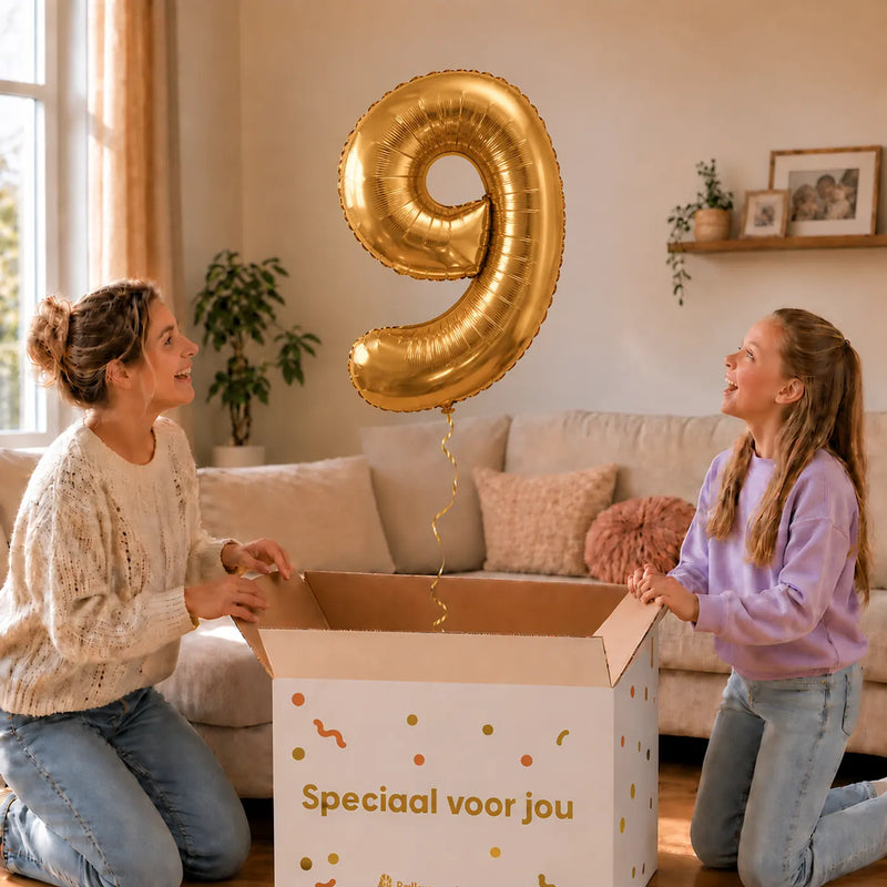 Cijfer 9 Helium Ballon Goud zweeft boven een geopende cadeaudoos bij een moeder en meisje in een warme woonkamer.