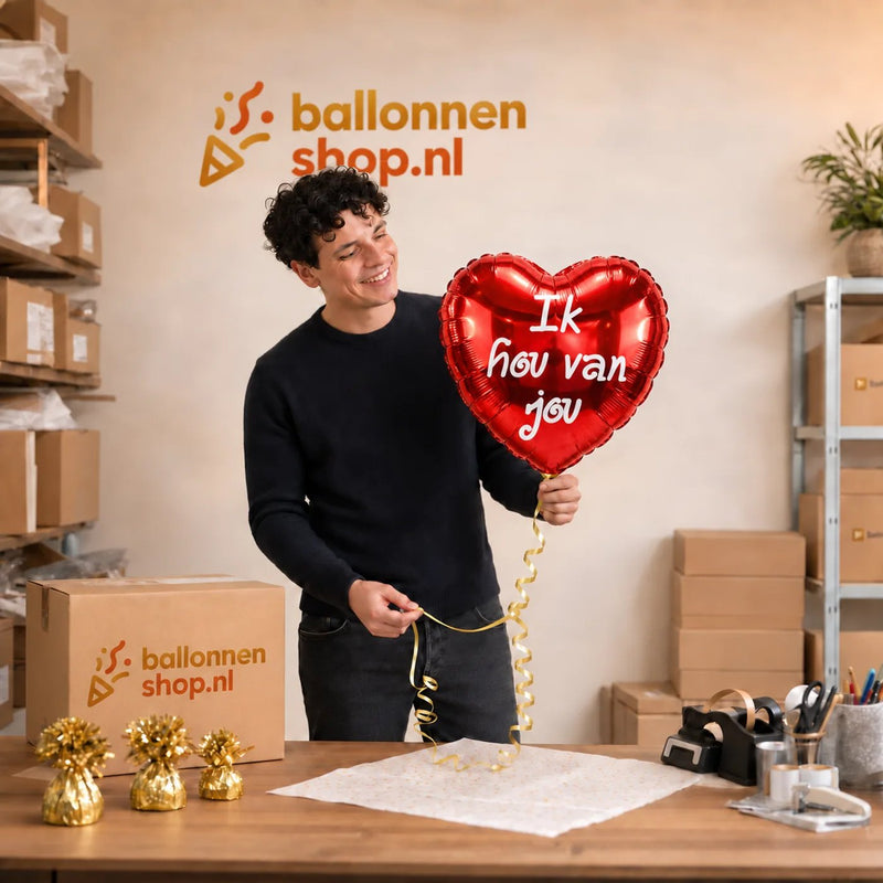 Jesse houdt de Hartjes Ballon Ik Hou Van Jou vast in de warme werkplaats van Ballonnenshop.nl.