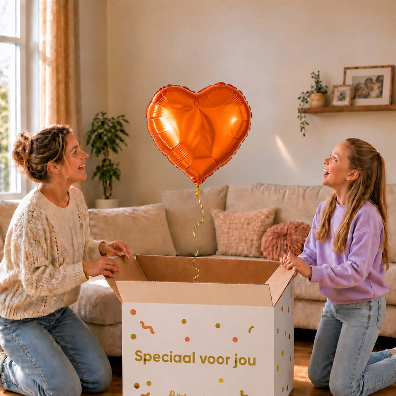 Moeder en meisje openen een cadeaudoos met een oranje hartvormige heliumballon van 45 cm.