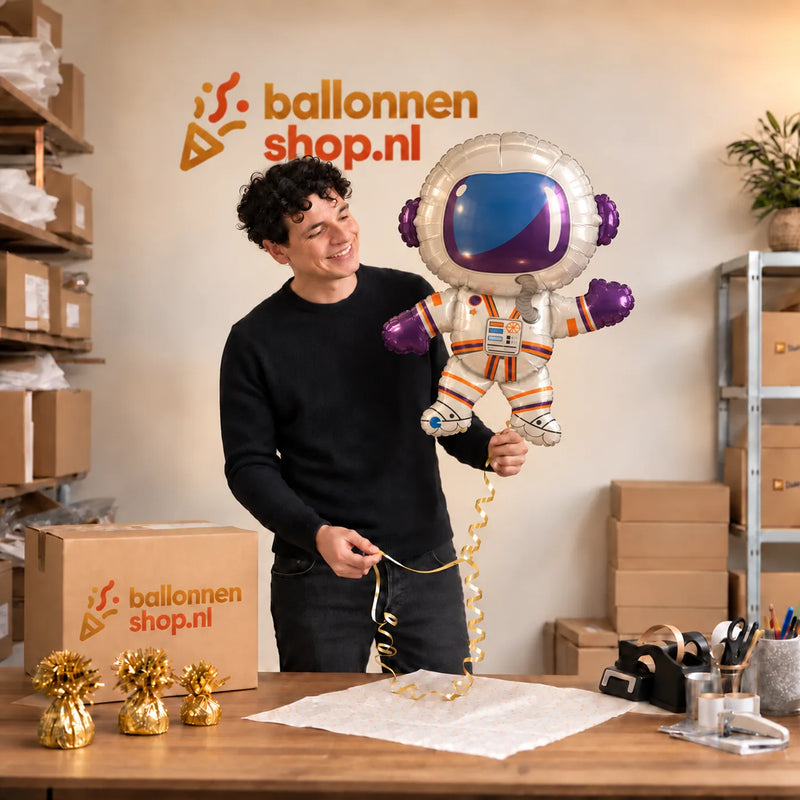 Jesse houdt de Astronaut Helium XL Ballon vast in de warme inpakruimte van Ballonnenshop.nl.