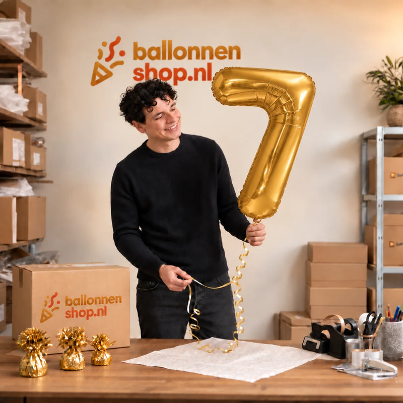 Jesse houdt de Cijfer 7 Helium Ballon Goud vast in de warme inpakruimte van Ballonnenshop.nl.
