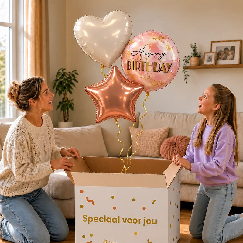 Happy Birthday Trosje Rose Goud/Wit/Marmer: moeder en dochter pakken het heliumgevulde ballonnentrosje uit een Speciaal voor jou-doos, met natuurlijk gekrulde gouden linten.