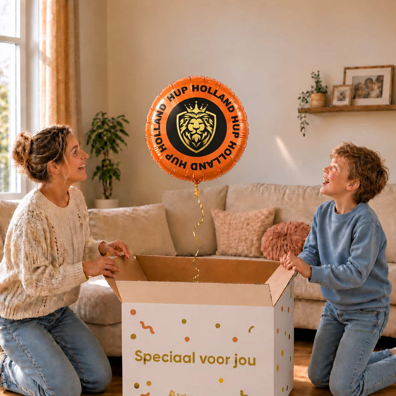 Moeder en zoon openen een cadeaudoos met de oranje Hup Holland Hup heliumballon van 43 cm.