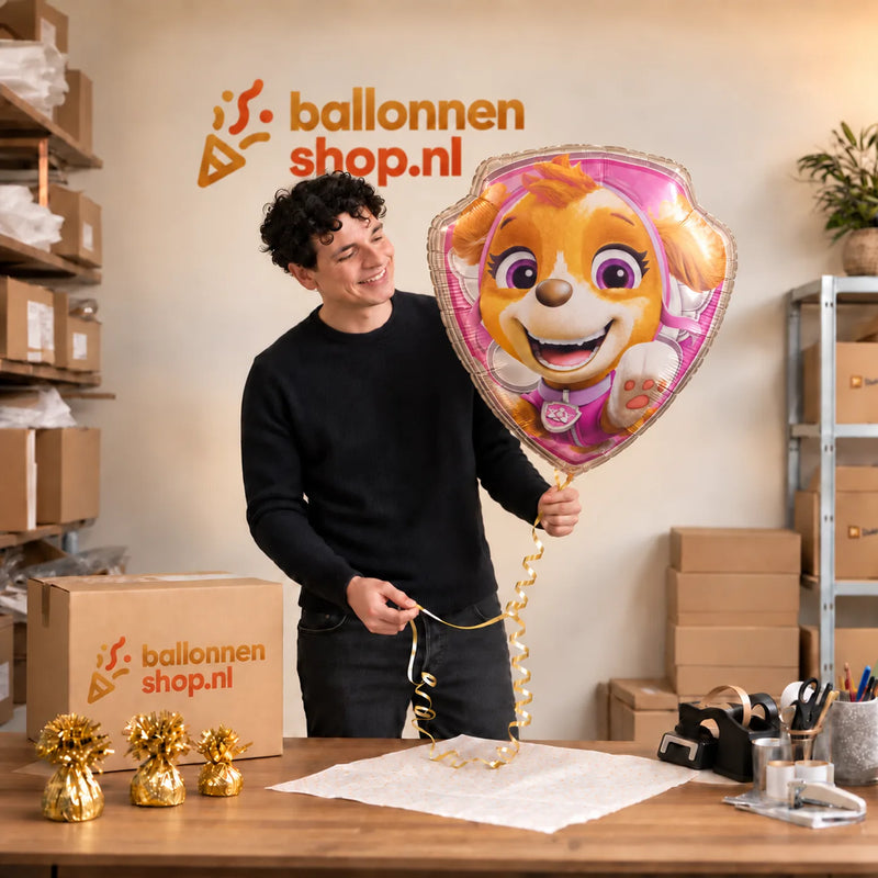 Jesse houdt de Skye Paw Patrol Helium XL Ballon vast in de warme inpakruimte van Ballonnenshop.nl.