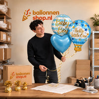 Jesse houdt Hello Little Boy Trosje Ballonnen vast in de warme werkplaats van Ballonnenshop.nl.