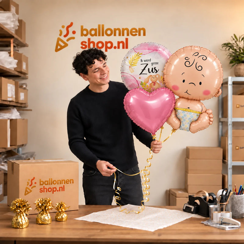 Jesse houdt Ik Word Grote Zus Trosje vast in de warme werkplaats van Ballonnenshop.nl.